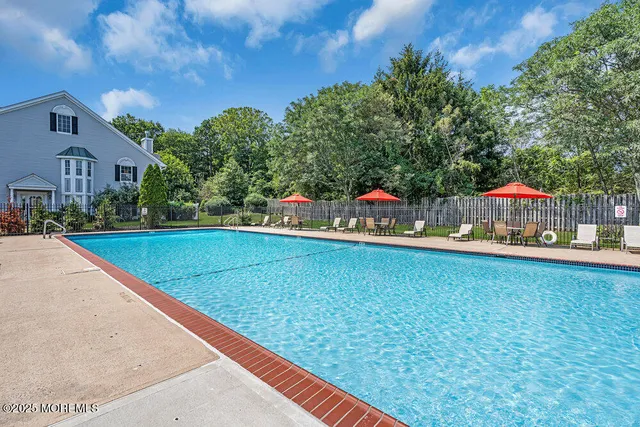 a view of swimming pool with outdoor seating and yard