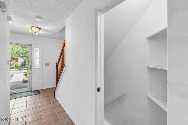 a view of an entryway with wooden floor and windows