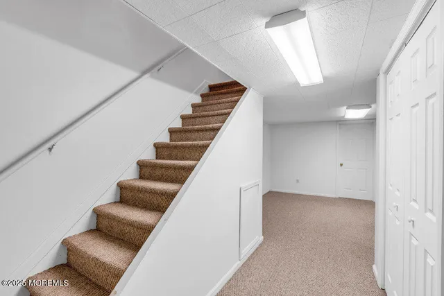 a view of staircase with furniture and stairs