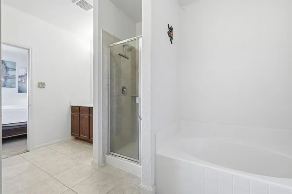 a bathroom with a bathtub and a shower