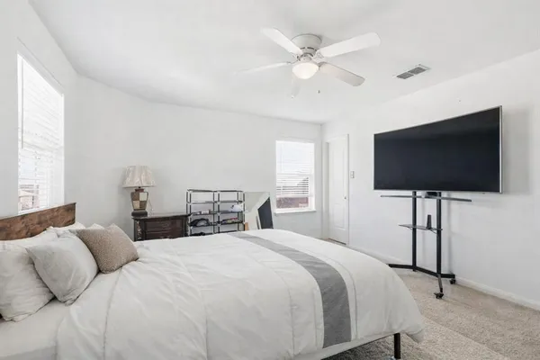 a bedroom with a bed and a flat screen tv