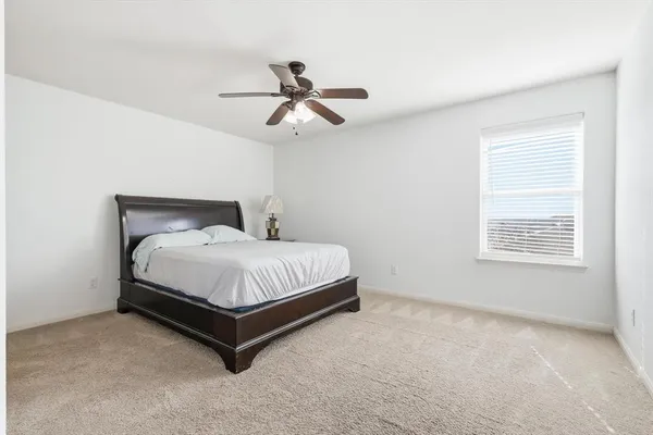 a bed sitting in a bedroom next to a window