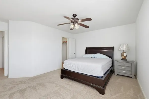 a bedroom with a bed and window
