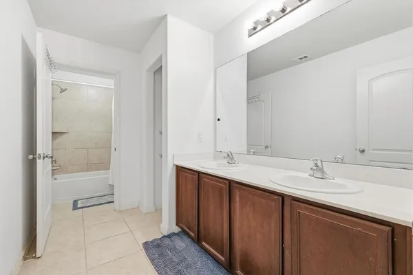 a bathroom with a sink double vanity and a mirror