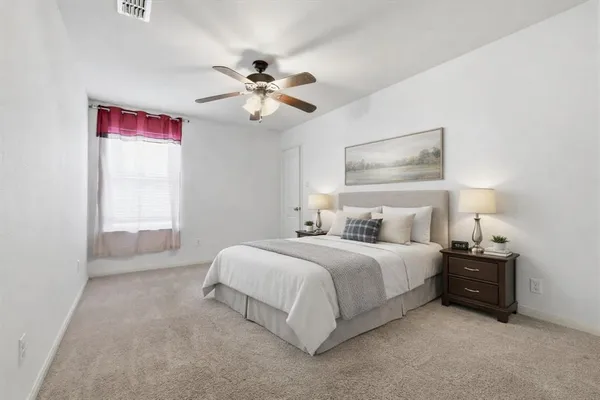 a bedroom with a bed and a chandelier