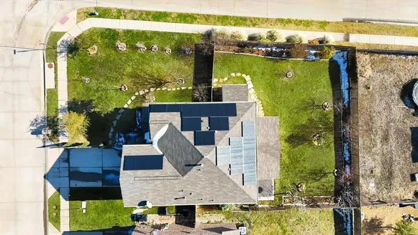 a front view of house with a garden and swimming pool
