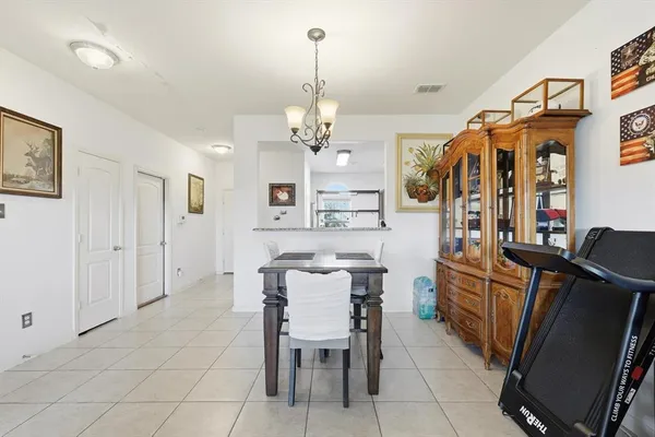 a view of a dining room with furniture and chandelier