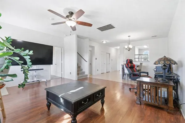 a living room with furniture and a flat screen tv