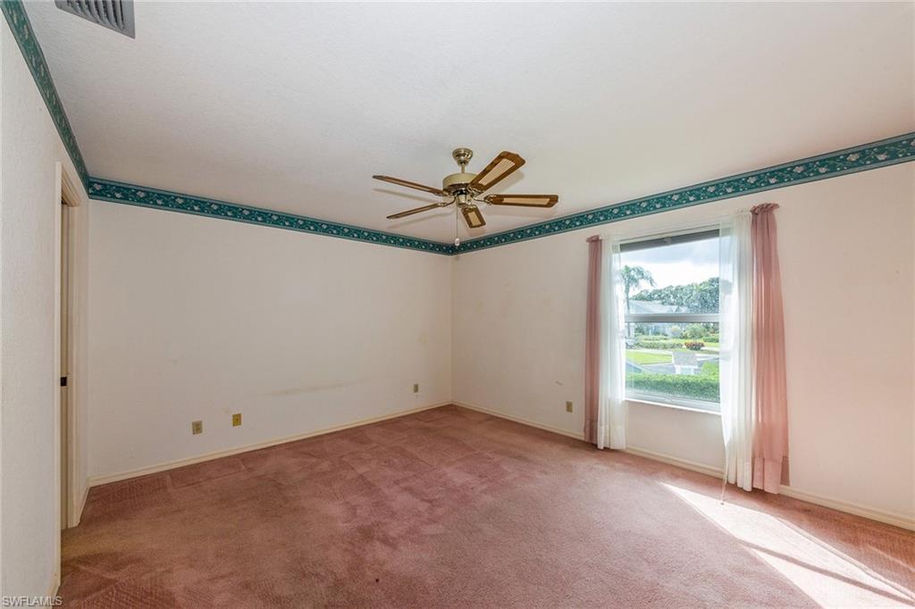 1535 Trafalgar Lane, Unit R201 Naples, FL 34116 - Photo 5 of 10 a view of a room with a window and a ceiling fan