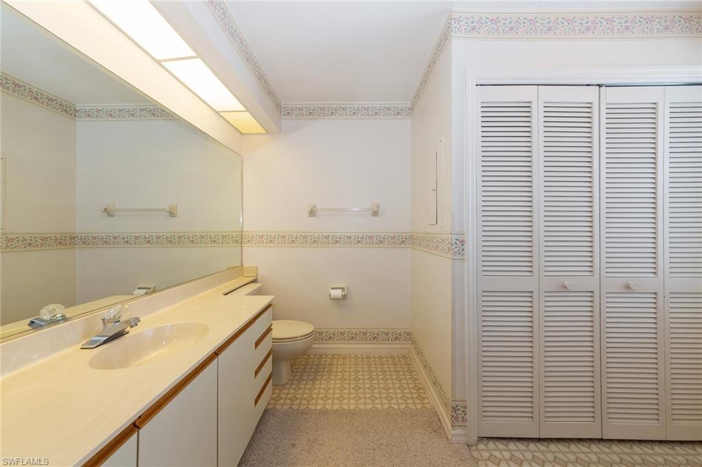 1535 Trafalgar Lane, Unit R201 Naples, FL 34116 - Photo 8 of 10 a bathroom with a sink a toilet and shower