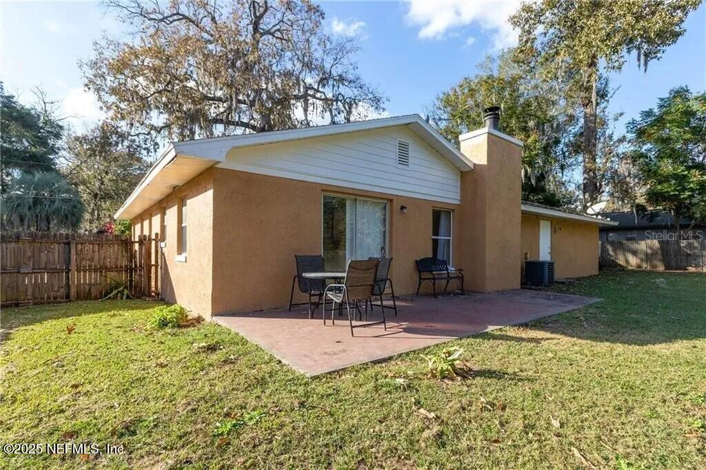 3991 Southeast 19th Avenue Ocala, FL 34480 - Photo 11 of 11 a view of a chair and table in backyard of the house