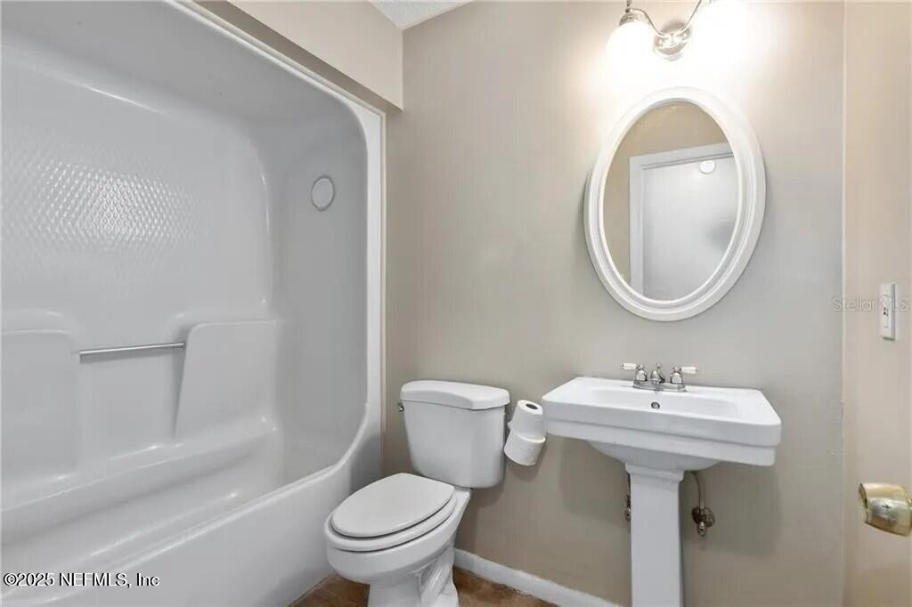 3991 Southeast 19th Avenue Ocala, FL 34480 - Photo 9 of 11 a bathroom with a sink toilet and a mirror