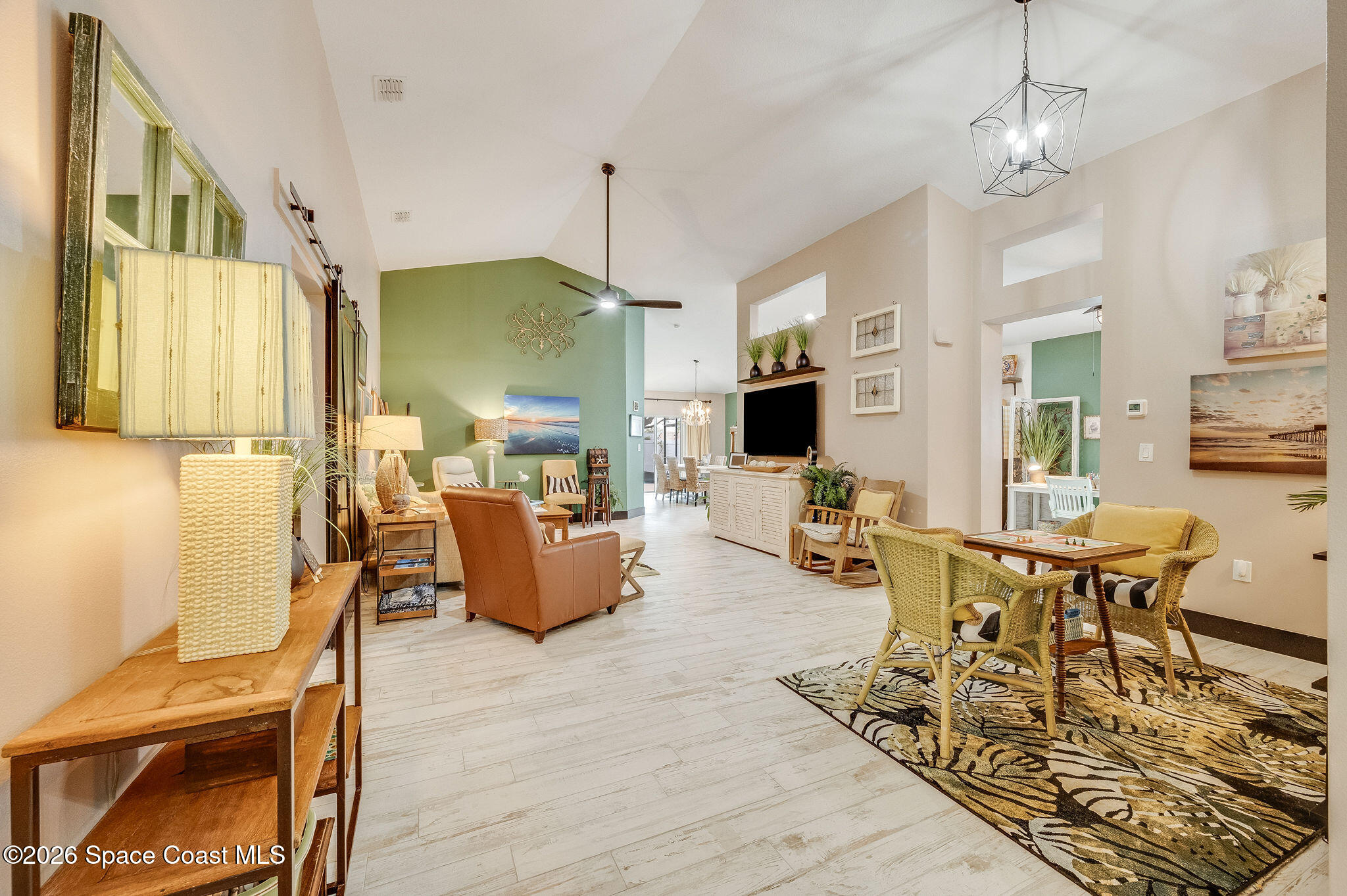 3911 Joslin Way Melbourne, FL 32904 - Photo 10 of 63 a living room with furniture kitchen view and a chandelier