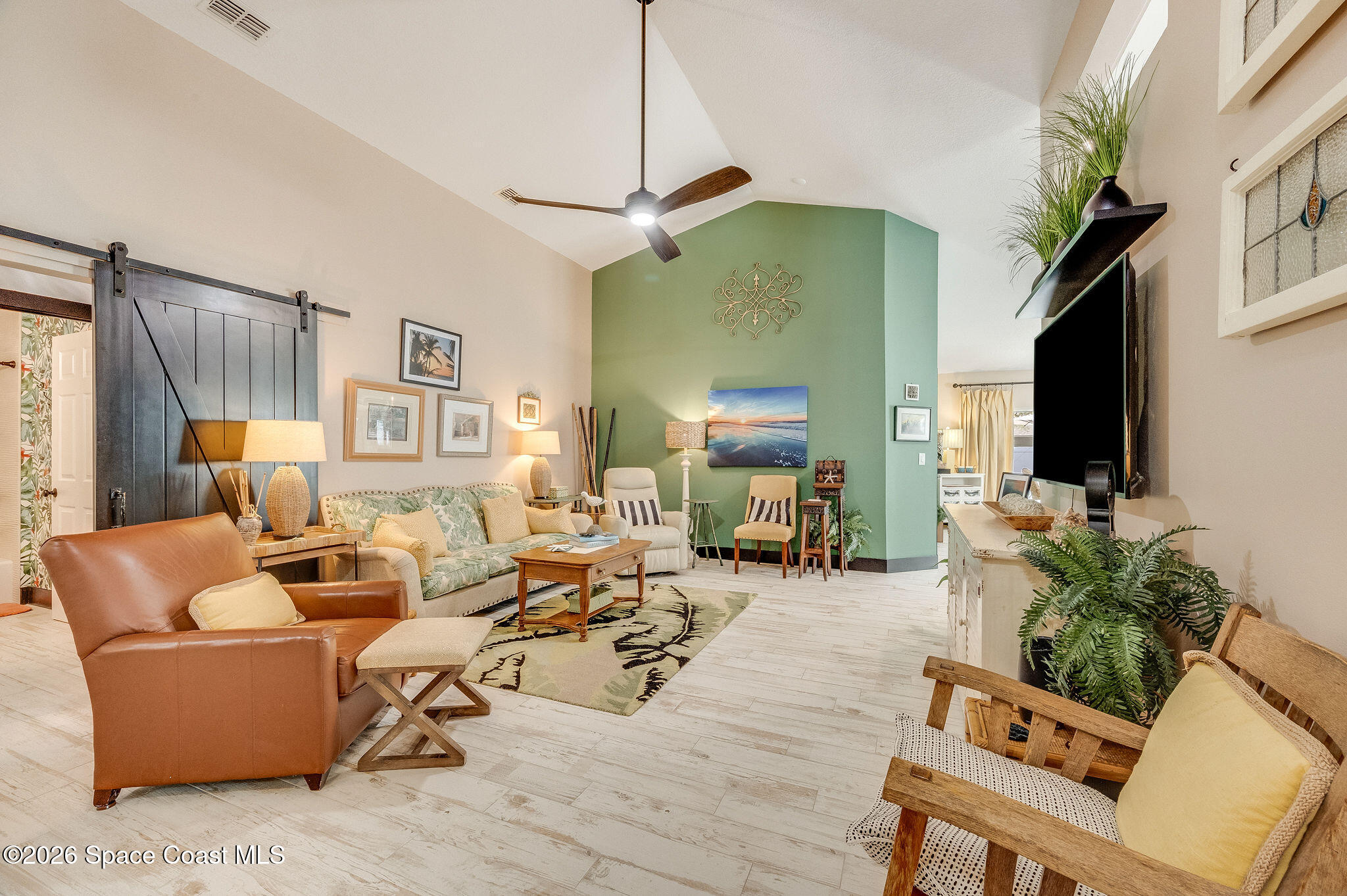 3911 Joslin Way Melbourne, FL 32904 - Photo 13 of 63 a living room with furniture and a flat screen tv