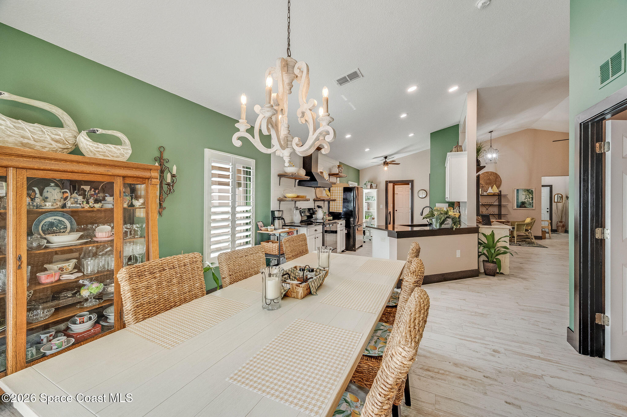 3911 Joslin Way Melbourne, FL 32904 - Photo 18 of 63 a view of a dining room and livingroom with furniture wooden floor a chandelier