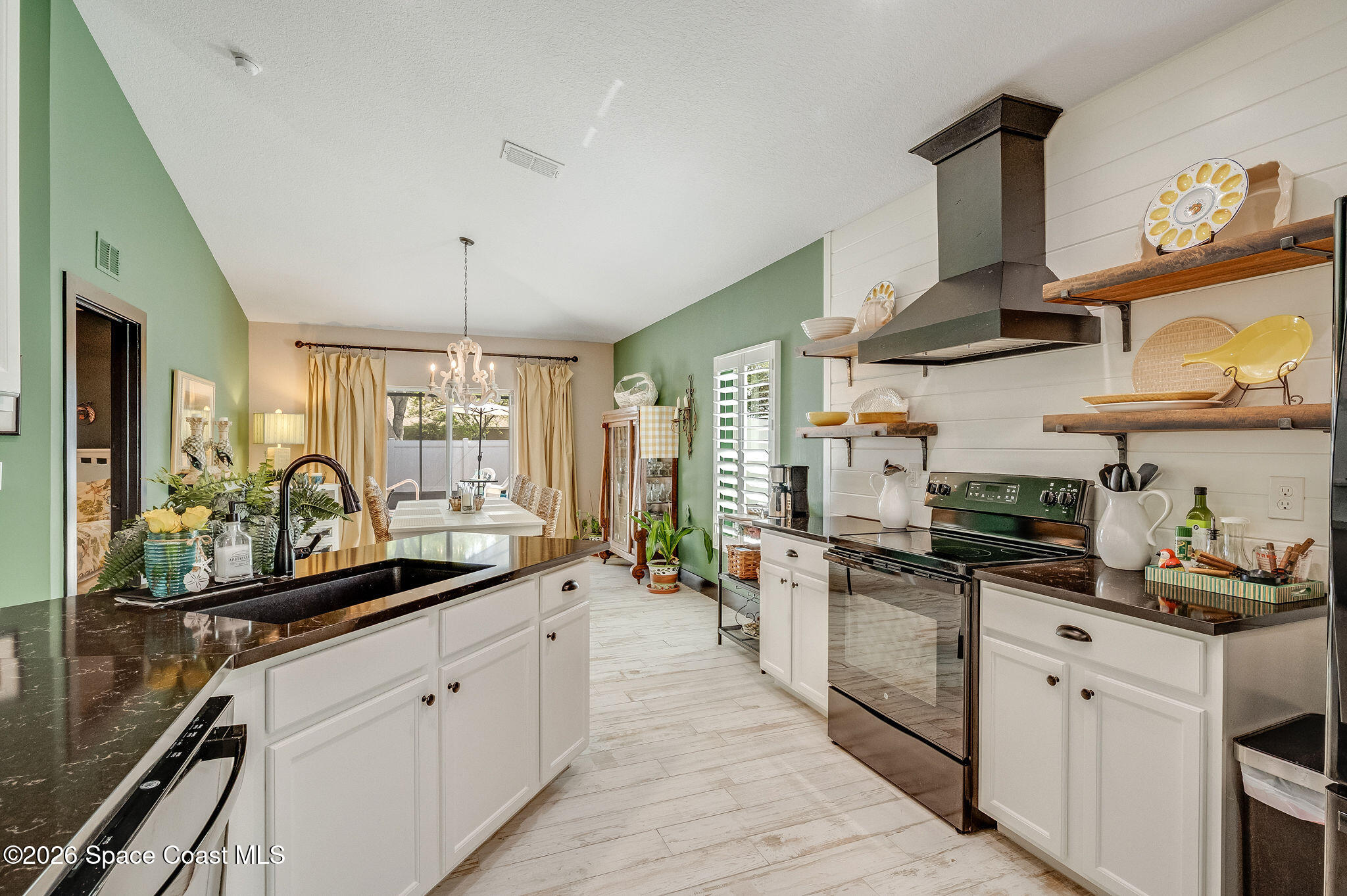 3911 Joslin Way Melbourne, FL 32904 - Photo 22 of 63 a kitchen with stainless steel appliances a sink stove and cabinets