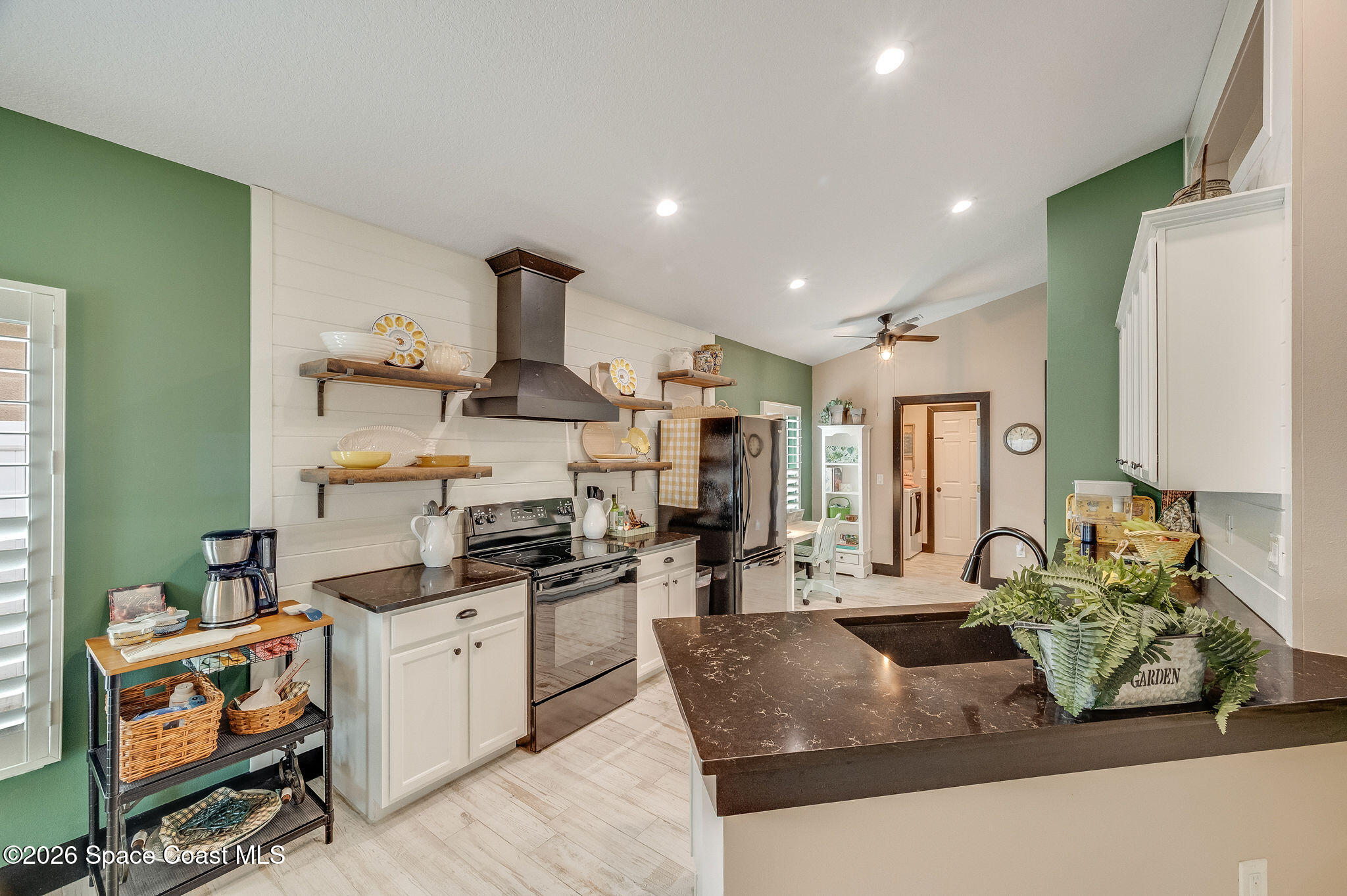 3911 Joslin Way Melbourne, FL 32904 - Photo 24 of 63 a large white kitchen with stainless steel appliances granite countertop a stove and a refrigerator