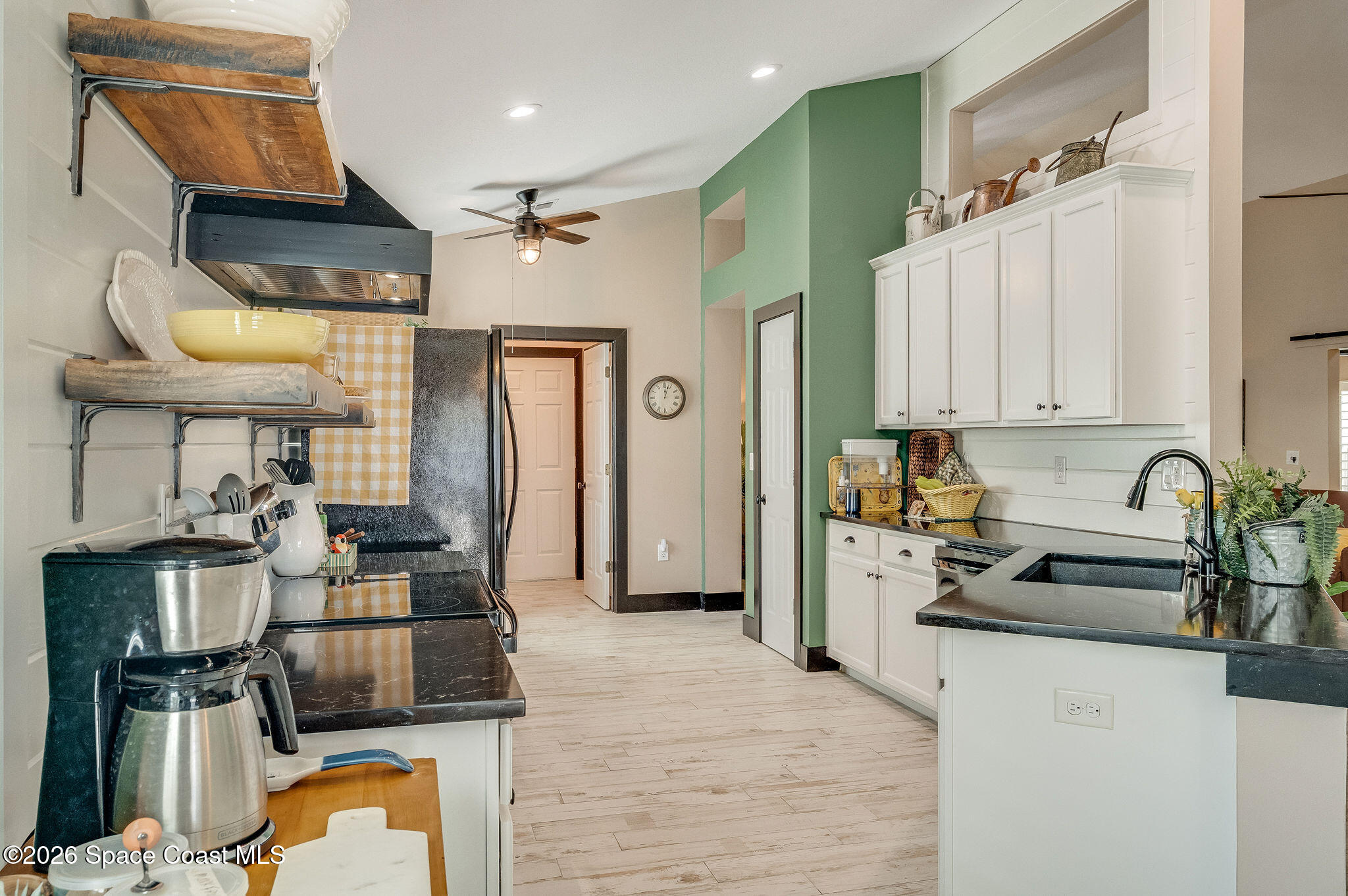3911 Joslin Way Melbourne, FL 32904 - Photo 25 of 63 a kitchen with a refrigerator and a stove top oven