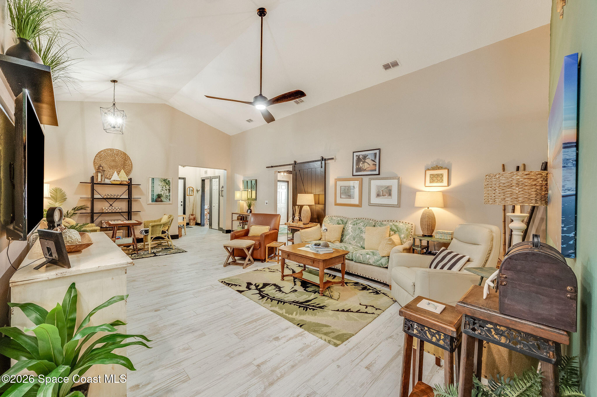 3911 Joslin Way Melbourne, FL 32904 - Photo 3 of 63 a living room with furniture kitchen view and a chandelier