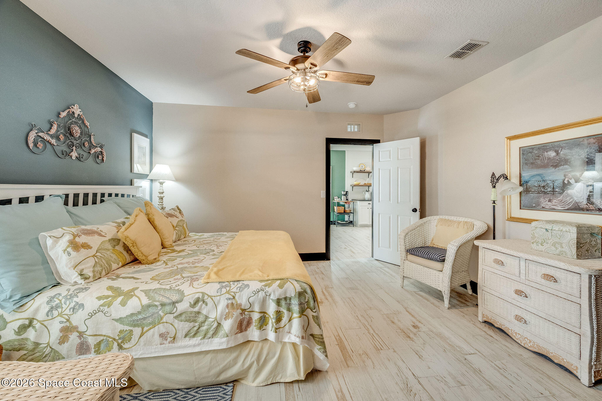 3911 Joslin Way Melbourne, FL 32904 - Photo 31 of 63 a bedroom with a large bed and a chandelier