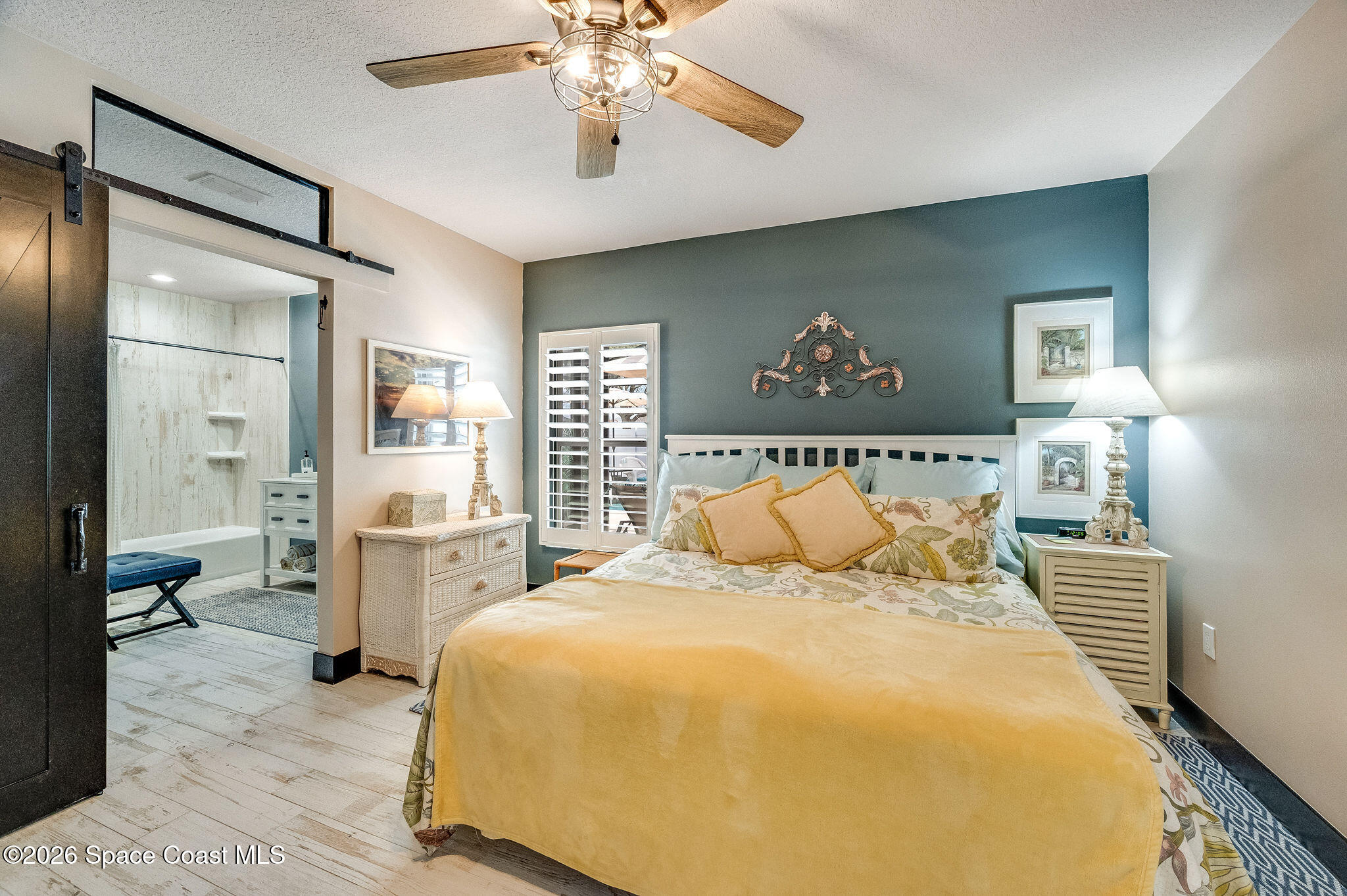 3911 Joslin Way Melbourne, FL 32904 - Photo 32 of 63 a bedroom with a large bed and a chandelier