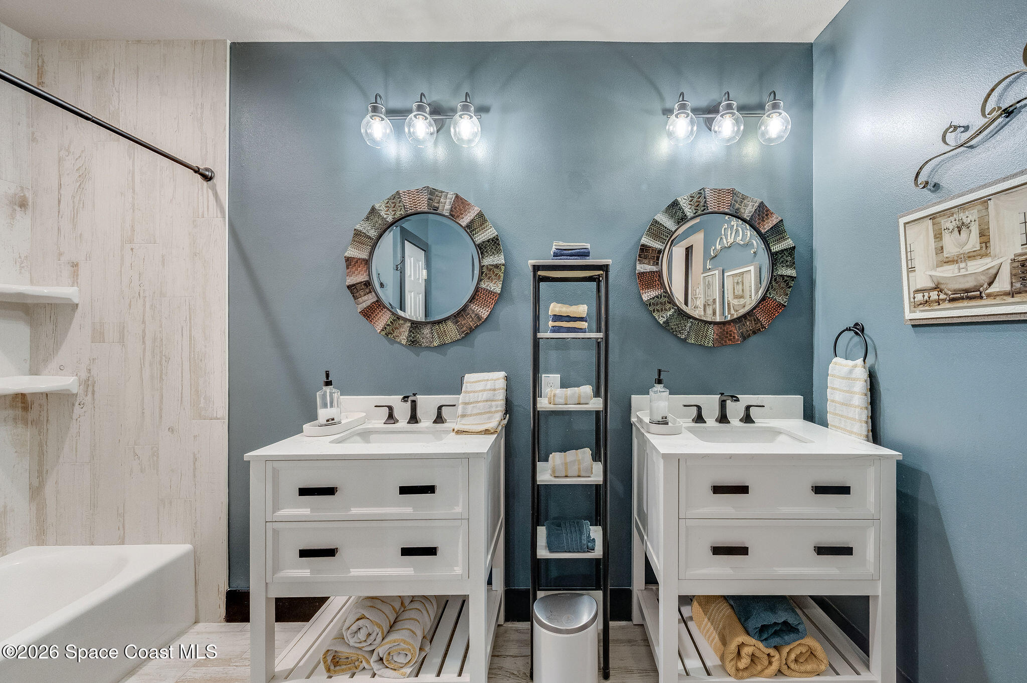 3911 Joslin Way Melbourne, FL 32904 - Photo 35 of 63 a bathroom with a sink vanity and mirror