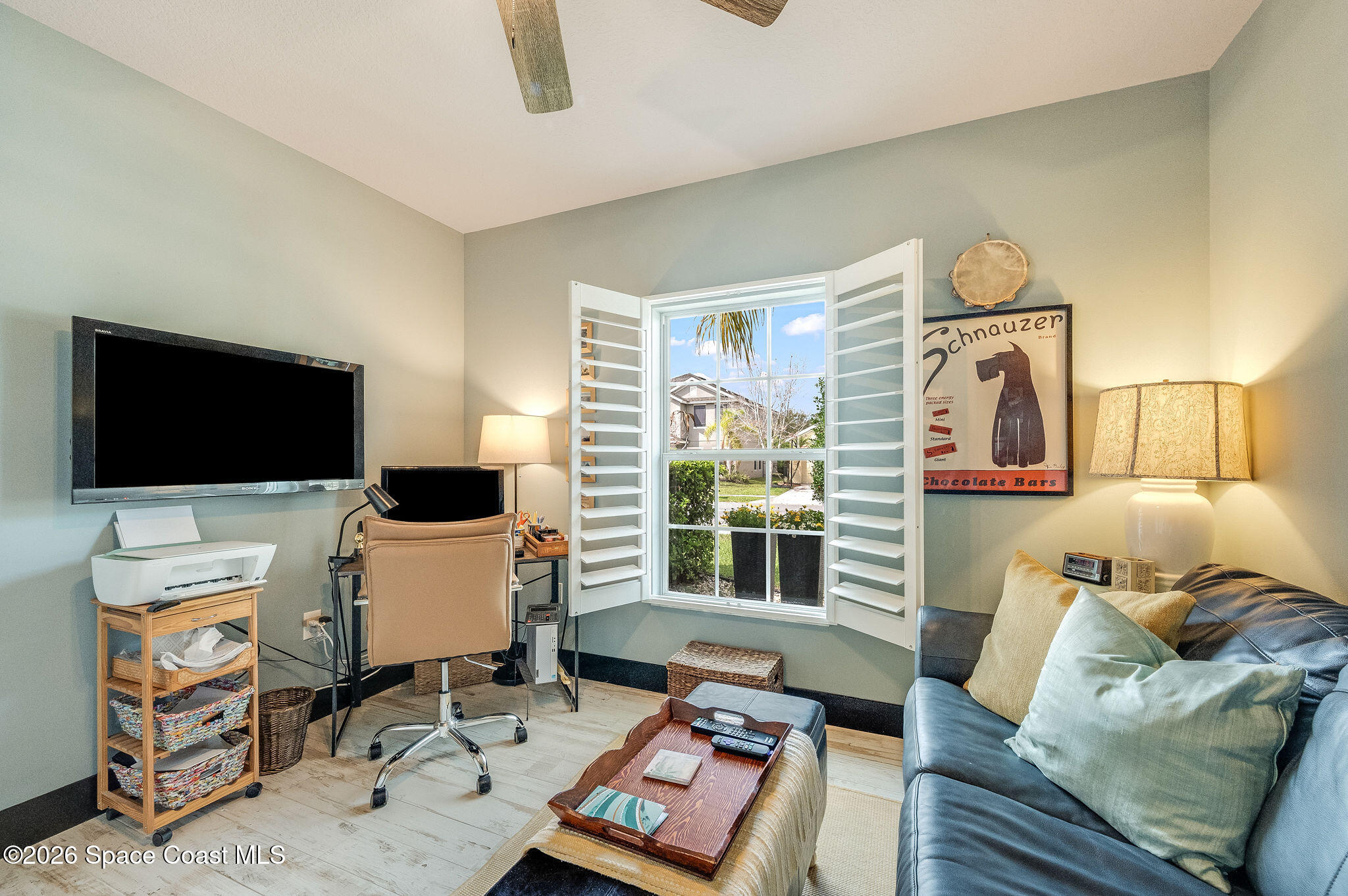 3911 Joslin Way Melbourne, FL 32904 - Photo 38 of 63 a living room with furniture and a flat screen tv