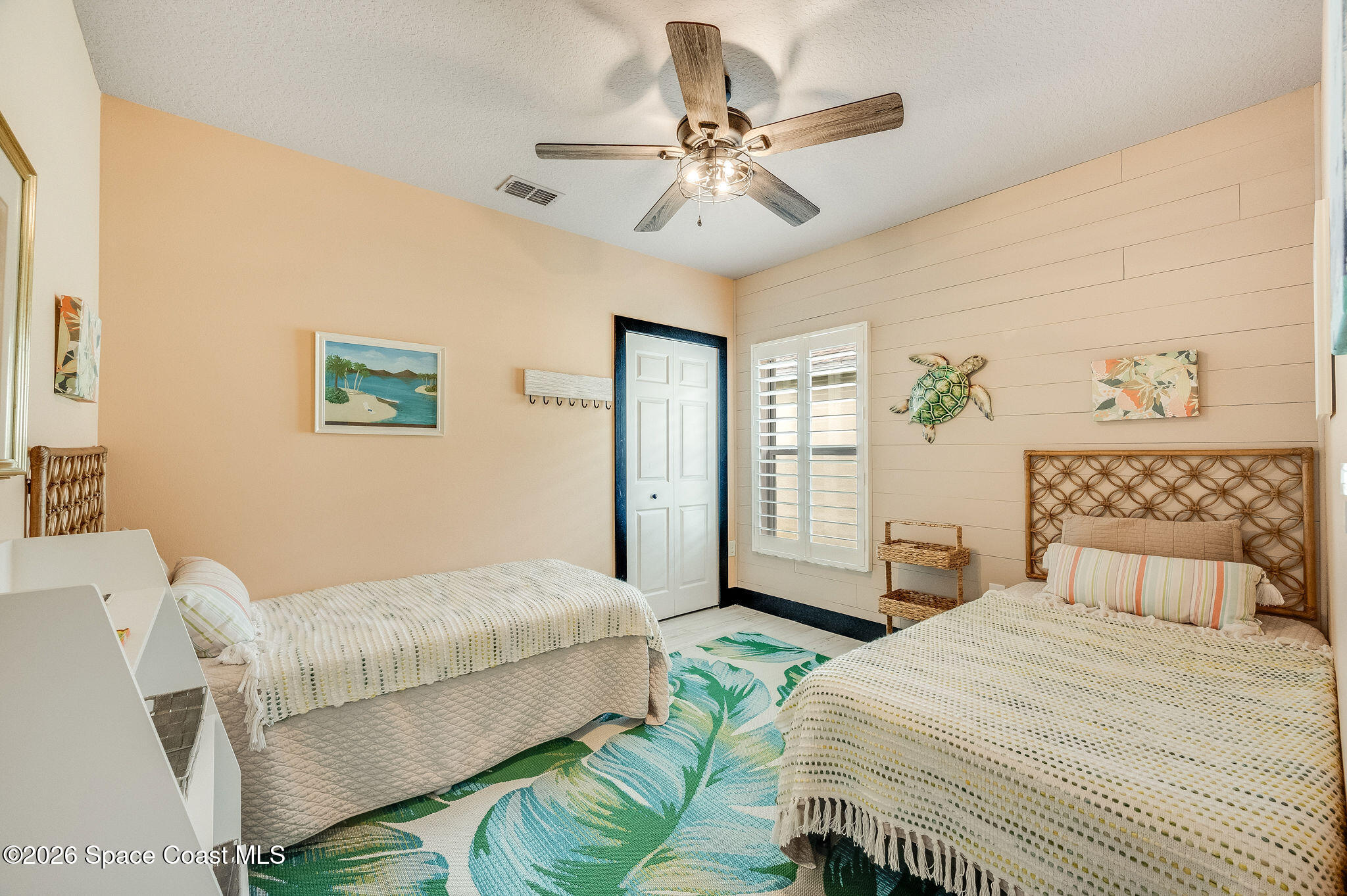 3911 Joslin Way Melbourne, FL 32904 - Photo 40 of 63 a bedroom with a bed and a chandelier