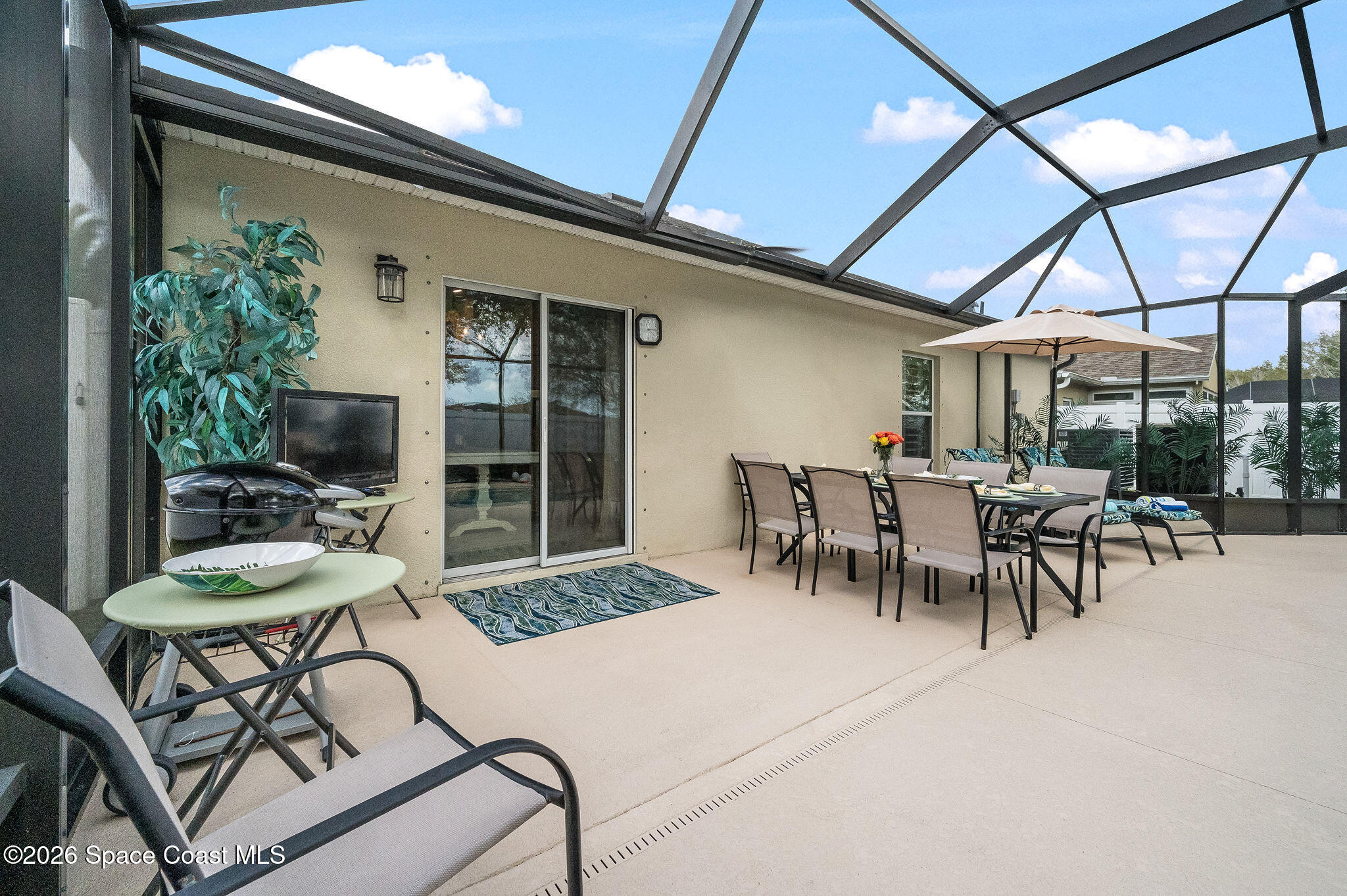3911 Joslin Way Melbourne, FL 32904 - Photo 44 of 63 a view of a patio with table and chairs and potted plants