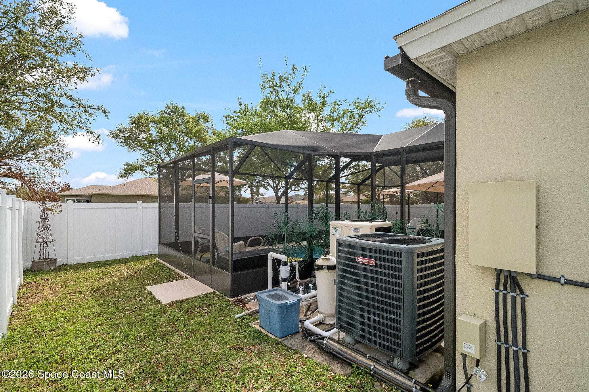 3911 Joslin Way Melbourne, FL 32904 - Photo 49 of 63 a view of a patio with a table and chairs under an umbrella
