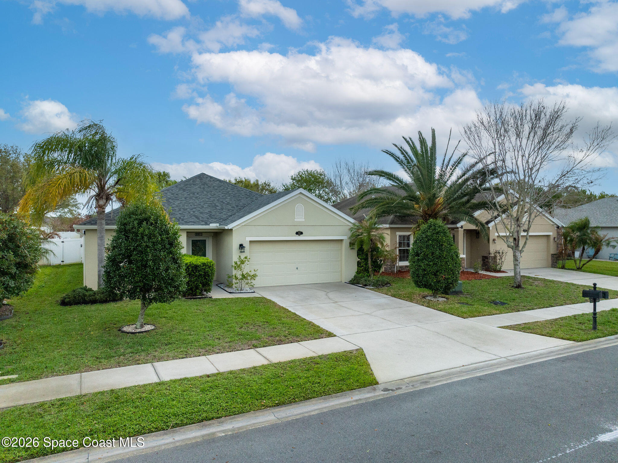 3911 Joslin Way Melbourne, FL 32904 - Photo 53 of 63 a front view of a house with a yard and garage