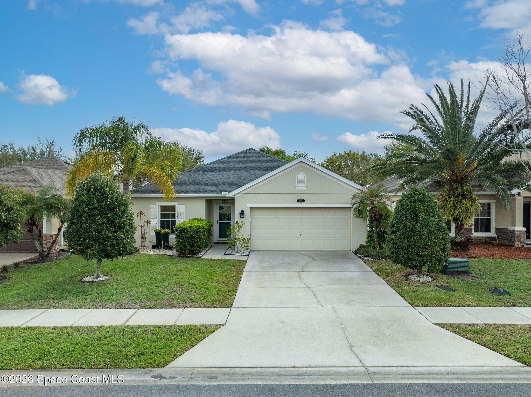 3911 Joslin Way Melbourne, FL 32904 - Photo 54 of 63 a front view of a house with a yard and trees