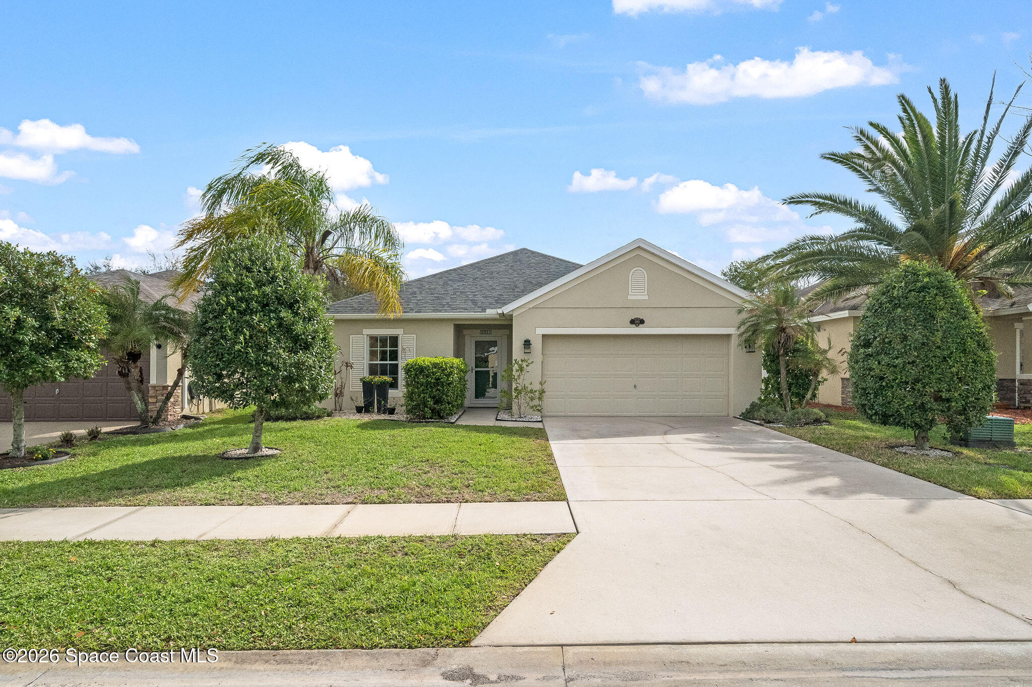 3911 Joslin Way Melbourne, FL 32904 - Photo 5 of 63 a front view of a house with a yard and garage