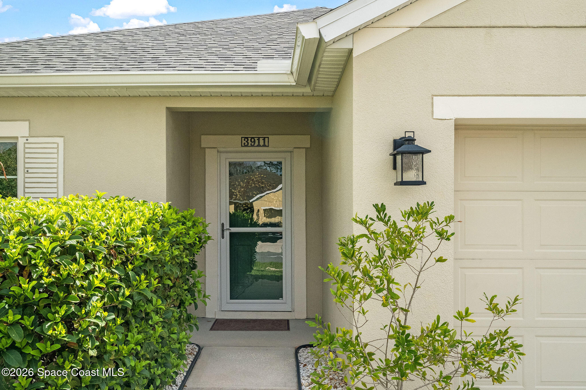 3911 Joslin Way Melbourne, FL 32904 - Photo 6 of 63 a potted plant in front of a door