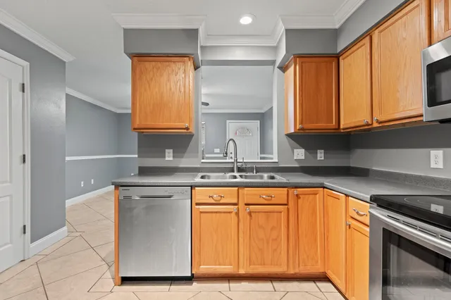 a kitchen with stainless steel appliances granite countertop a sink stove and cabinets