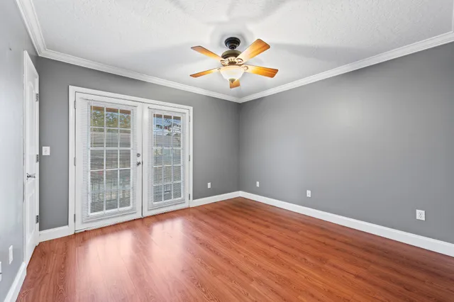 wooden floor in an empty room with a window
