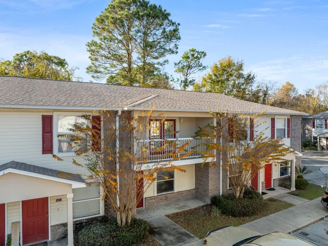 a front view of a residential apartment building with a yard