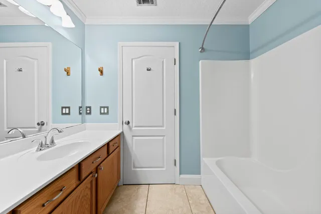 a bathroom with a tub sink and mirror