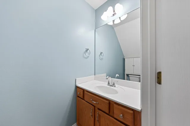 a bathroom with a sink vanity and a mirror