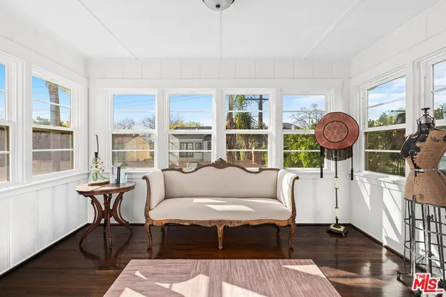 a living room with furniture a table and a large window