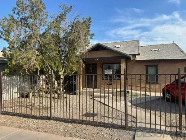 a view of a house with a iron gate
