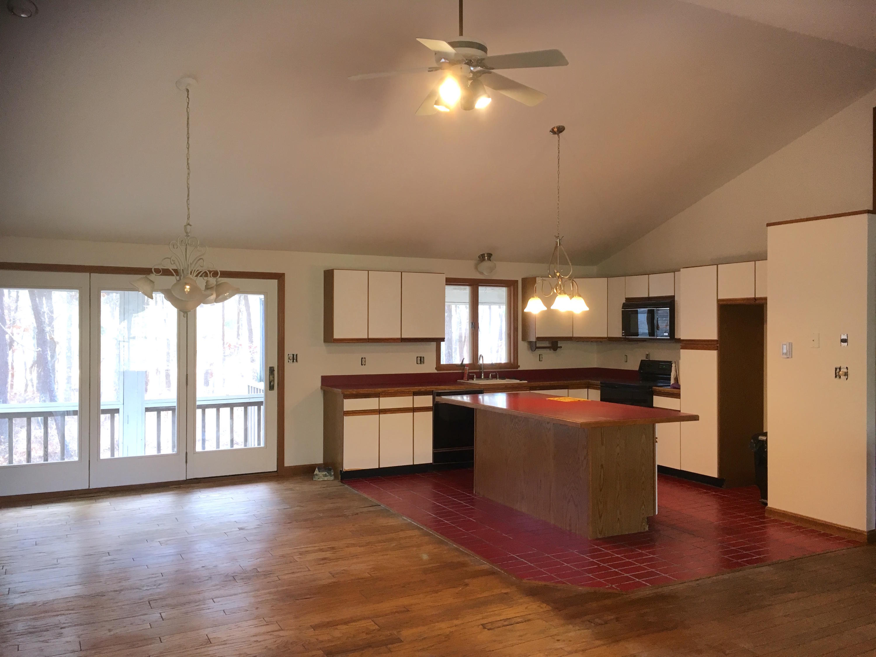 2 Pontiac Road Mashpee, MA 02649 - Photo 4 of 15 a kitchen with stainless steel appliances granite countertop a refrigerator a sink dishwasher a stove and a dining table with wooden floor