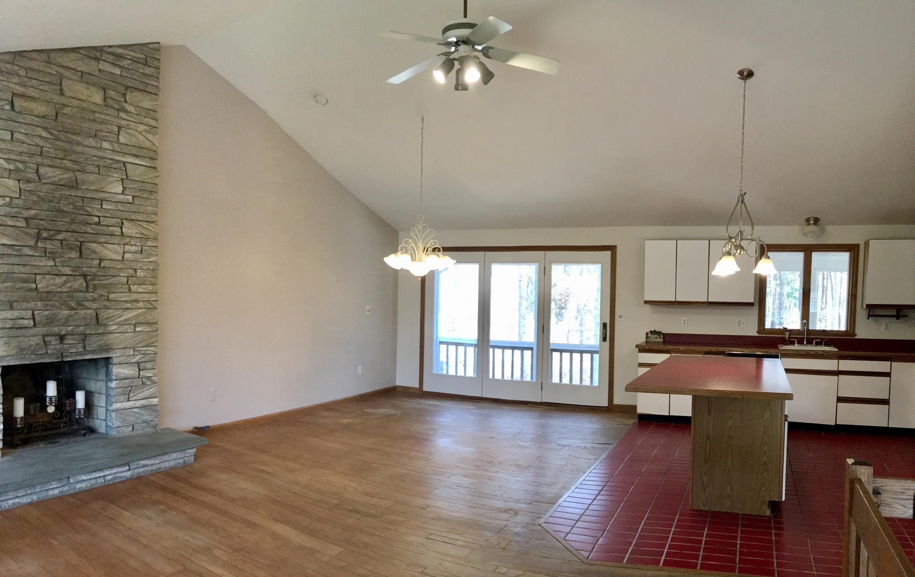 2 Pontiac Road Mashpee, MA 02649 - Photo 5 of 15 a open kitchen with granite countertop a stove top oven a sink dishwasher and a fireplace with wooden floor
