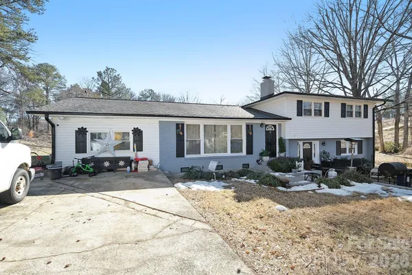 a front view of house with yard outdoor seating and barbeque oven