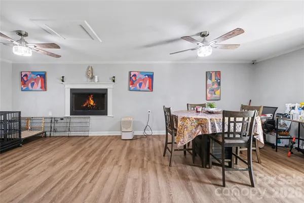 a dining room with furniture a chandelier and wooden floor