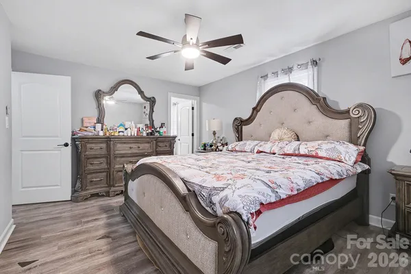 a bedroom with a bed and a dresser