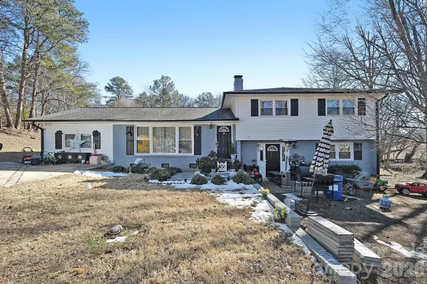 a front view of a house with yard patio and fire pit