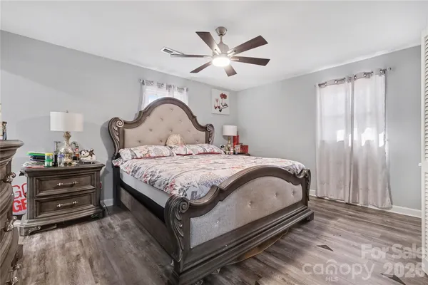 a bedroom with a bed and a dresser with mirror