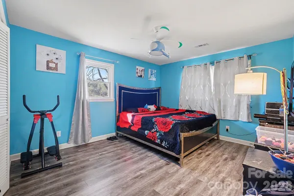 a bedroom with a bed and a chandelier