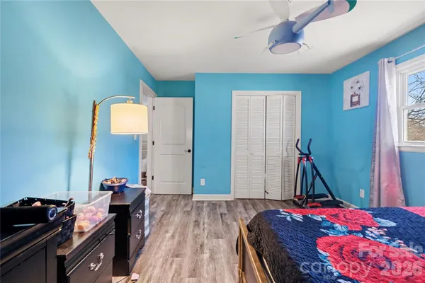 a bedroom with bed and a chandelier